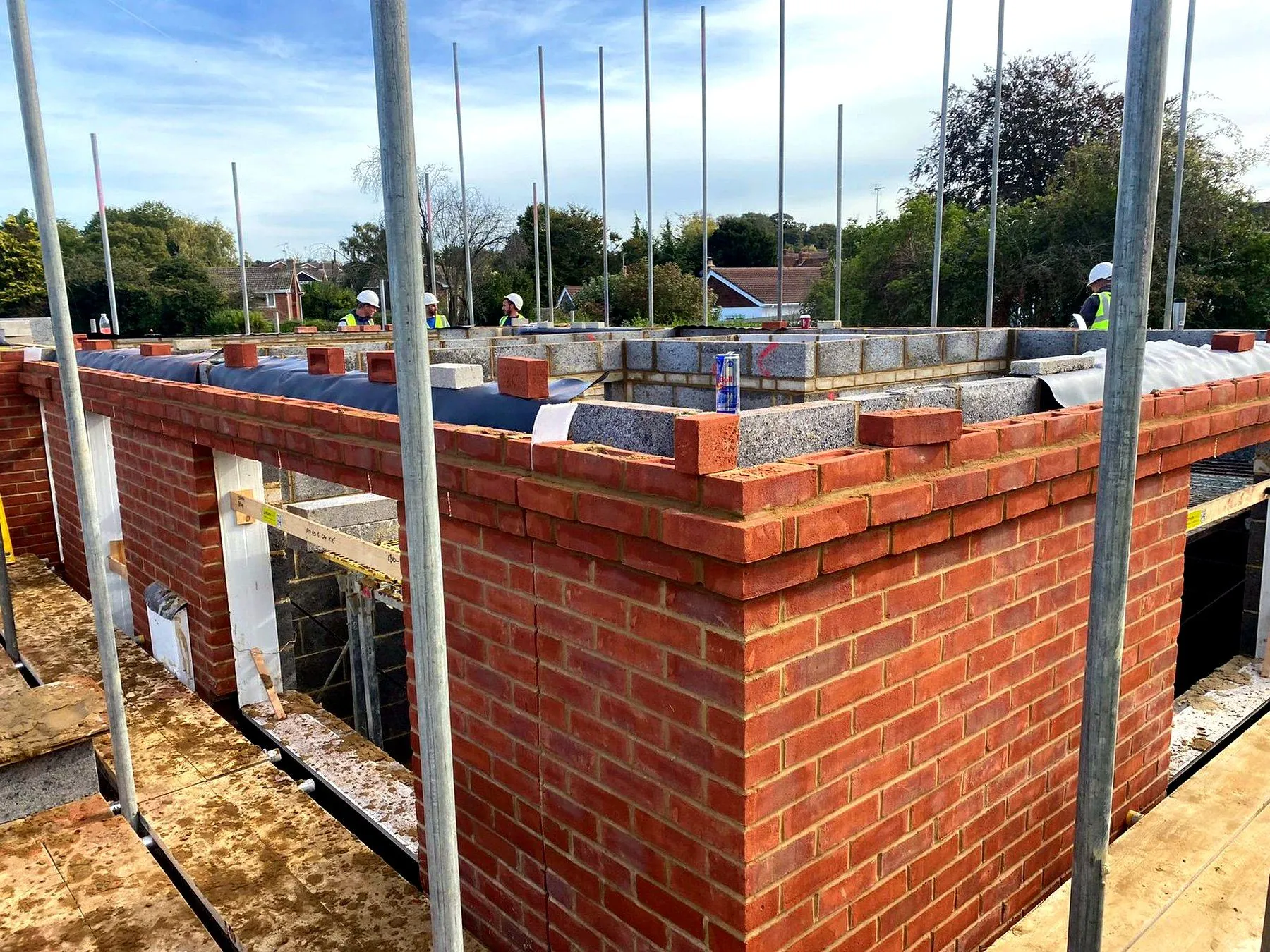 LS Brickwork Ltd team building a chimney stack on site